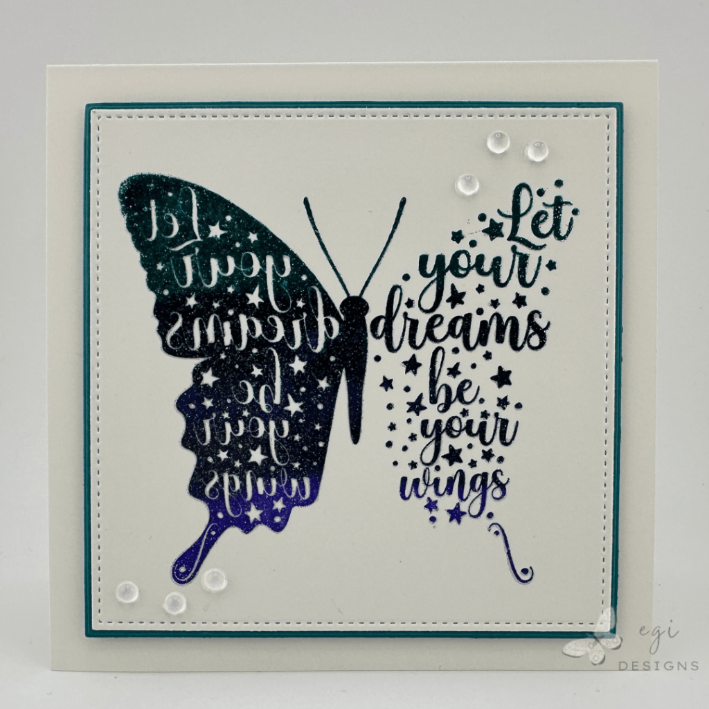 photo of the front of card using the Gina K Designs 'Let Your Dreams Be Your Wings' Stamp Set, with Tranquil Teal, In the Navy, and Dark Lilac Inks for the ombre stamping