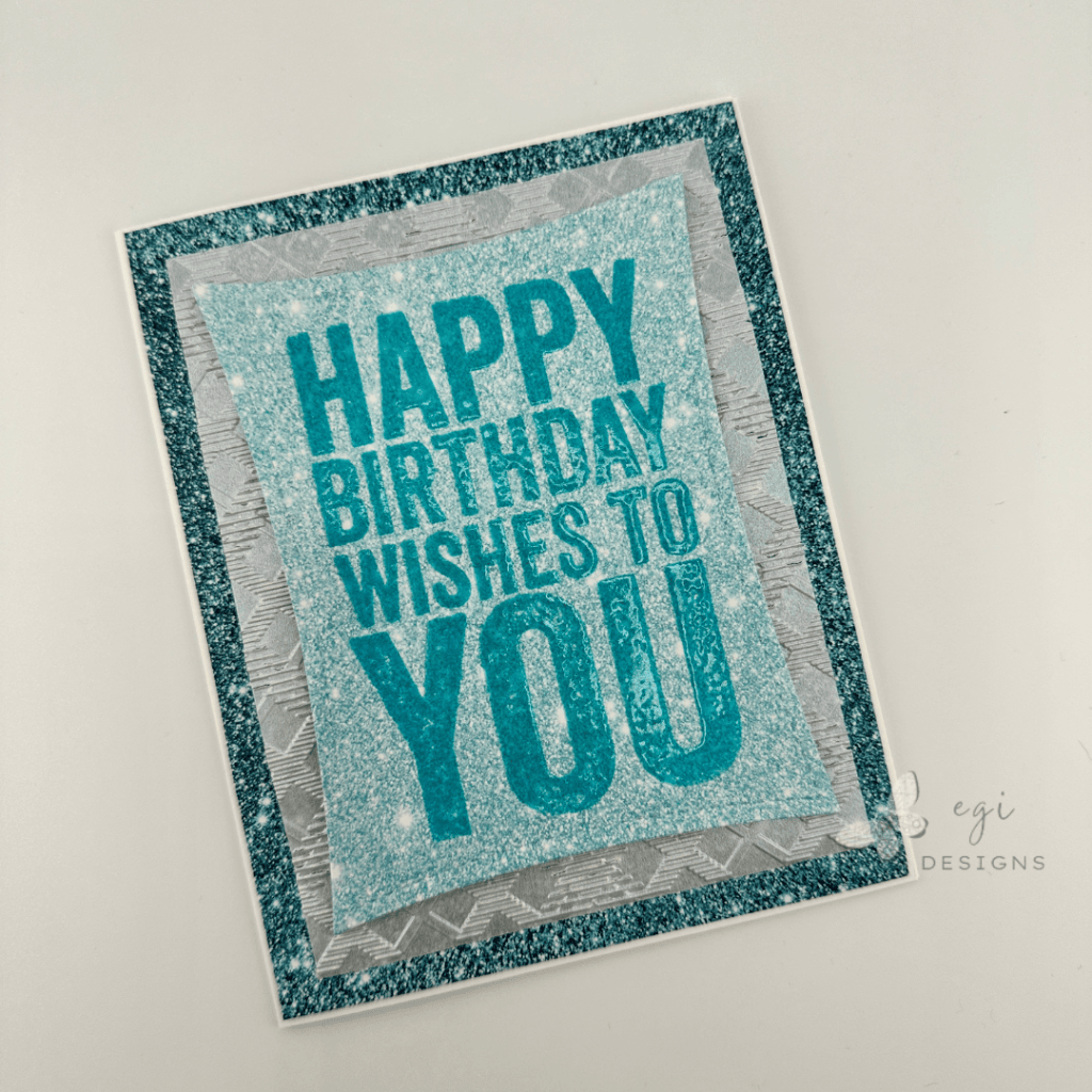 photo of Masculine Birthday Card Using Tim Holtz Bold Sayings Stamp Set, Kat Scrappiness Blue Glitter Paper and Stitched Wacky Frames, Pear Blossom Press Vellum, Simon Says Stamp Thread Plaid Embossing Folder
