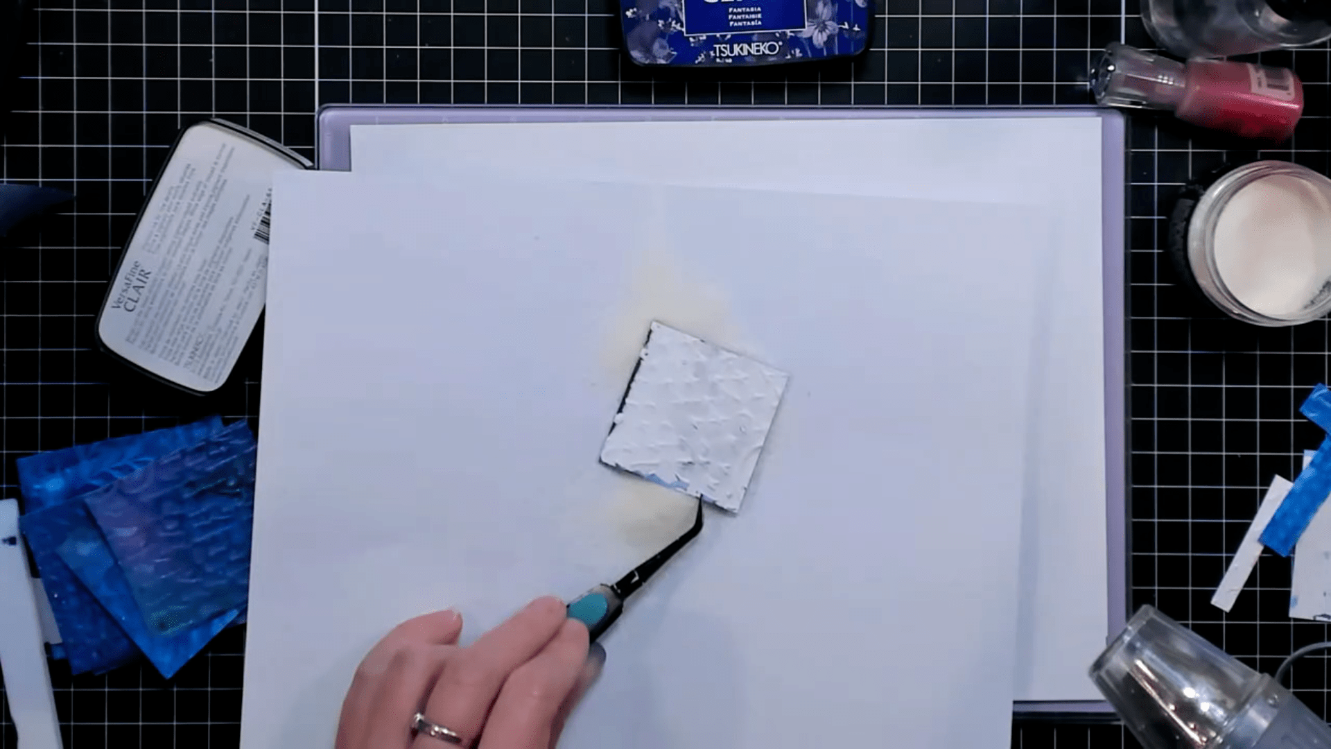photo of Dipping the Panel into the Dylusions Dyamond Rocks Embossing Powder after Blackout Technique