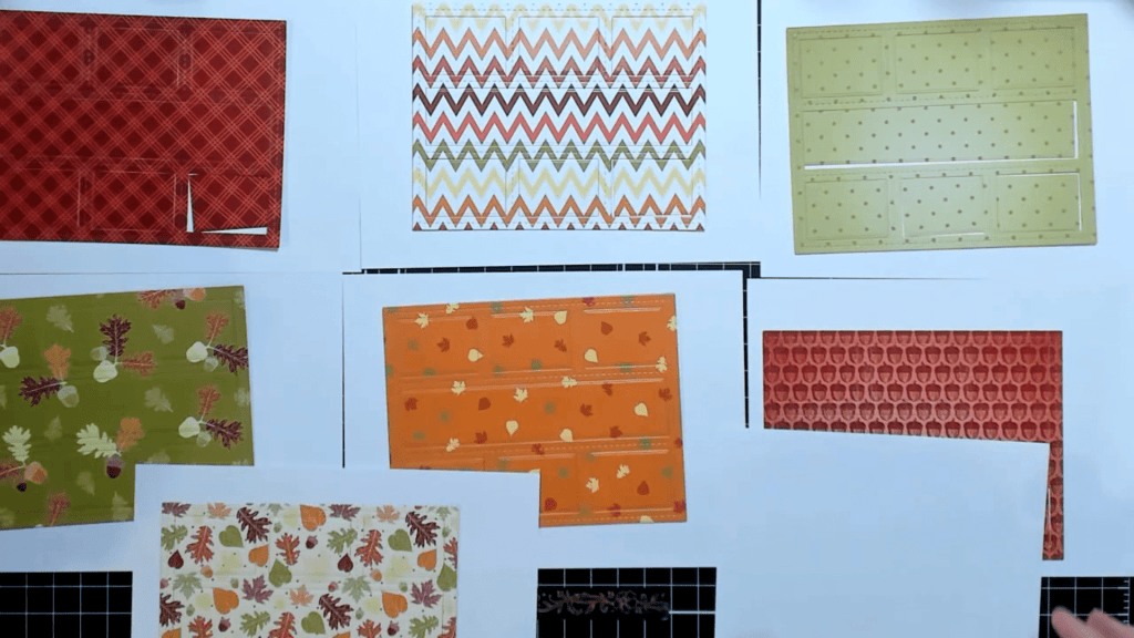 photo of Seven Sheets of Patterned Paper Die Cut with Postage Die