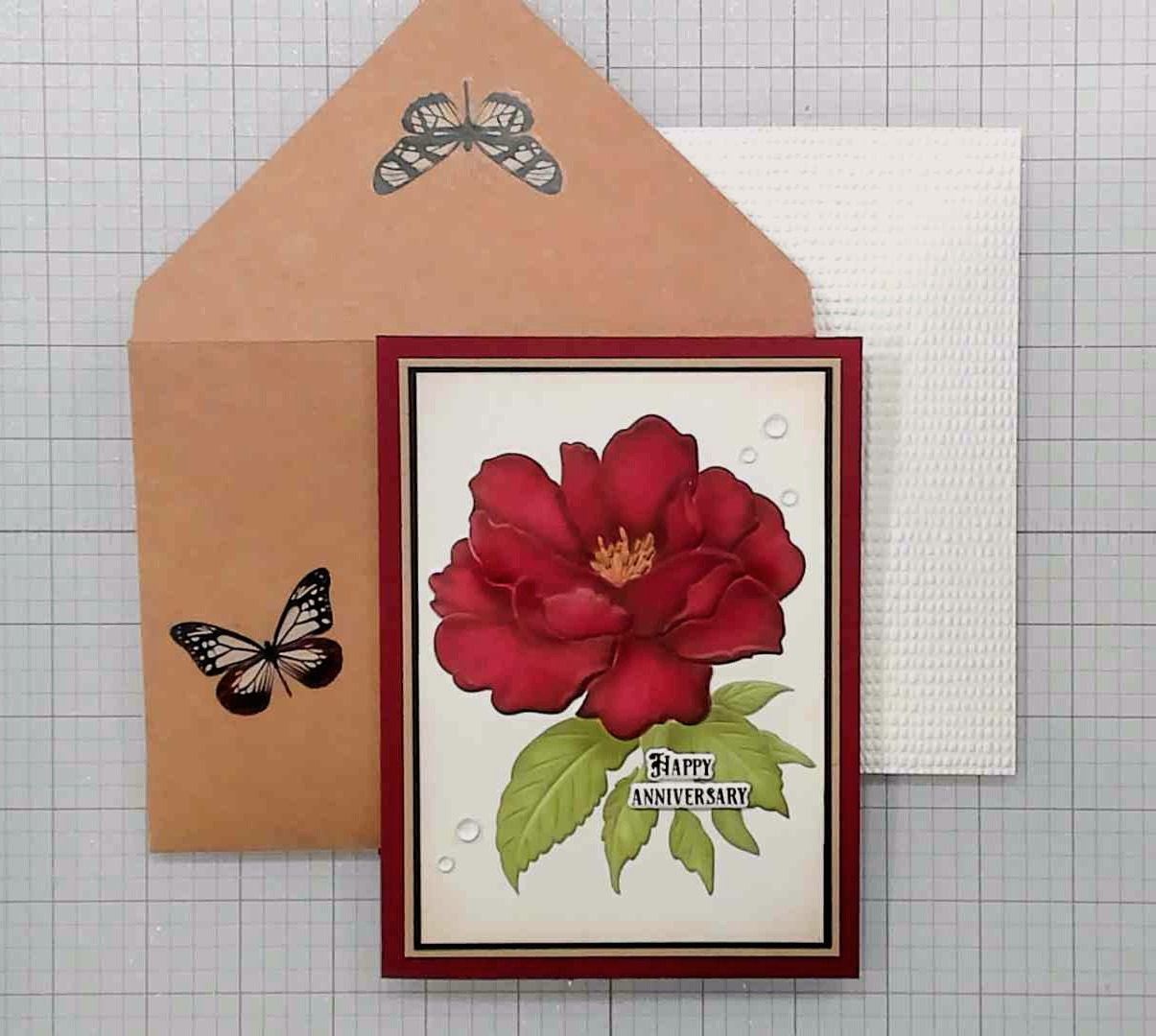 photo of completed card, decorated envelope, and protective mailing layer