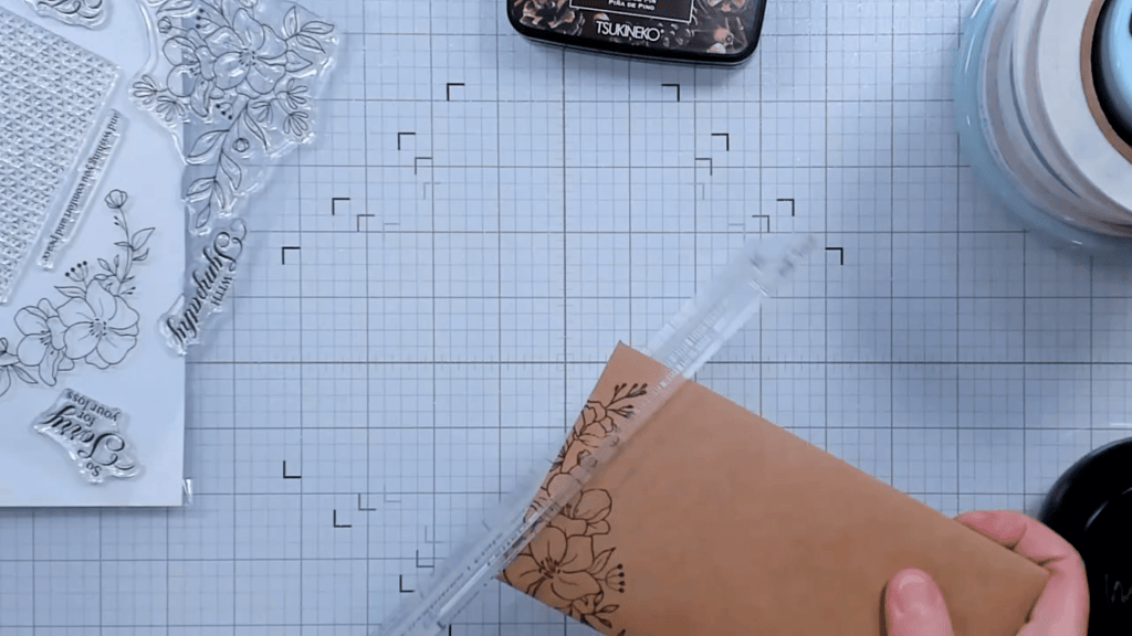 photo of Using USPS template to measure the thickness of the card and envelope.